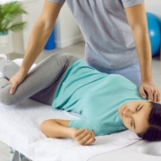 chiropractor performing therapy to female patient