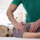 chiropractor doing spinal adjustment on female patient