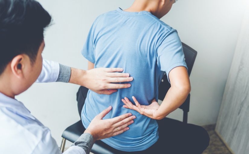 chiropractic doctor doing back adjustment