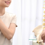 Female patient being shown spine model