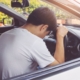 Man on car accident in front of car