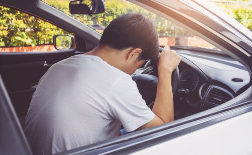 Man on car accident in front of car