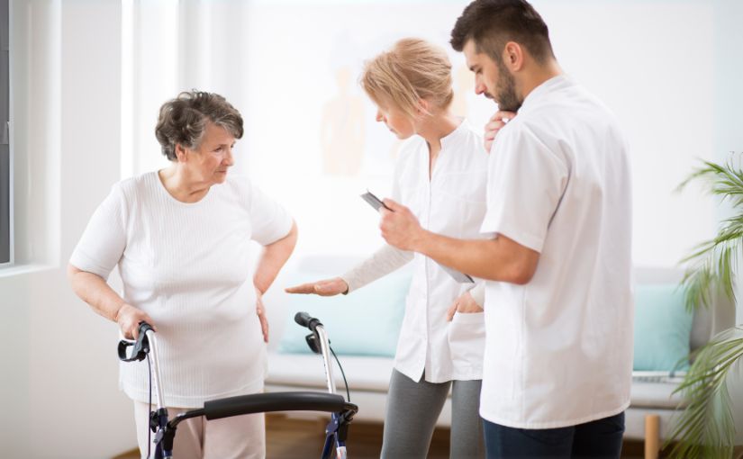 Chiropractic doctor talking to stroke patient